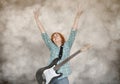 Female guitar player with hands up showing peace sign