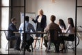 Middle-aged businesswoman lead meeting make whiteboard presentation Royalty Free Stock Photo