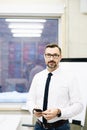 Middle aged handsome manager businessman in white shirt at office