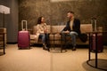 Business partners, businessman and businesswoman negotiating in a private meeting room in the airport departure terminal meeting Royalty Free Stock Photo