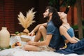 Couple in love is reading book together during picnic on lawn in their courtyard Royalty Free Stock Photo