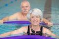 middle aged happy couple in swimming pool Royalty Free Stock Photo