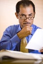 Middle-aged Hispanic businessman working in office