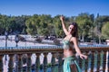 Middle-aged Hispanic woman, with green water color dress and rhinestones, to dance belly dance, making figures while dancing next Royalty Free Stock Photo