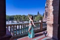 Middle-aged Hispanic woman, with green water color dress and rhinestones, to dance belly dance, making figures while dancing next Royalty Free Stock Photo