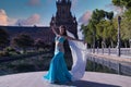 Middle-aged Hispanic woman in turquoise dress with rhinestones, belly dancing with a white veil. Belly dance concept Royalty Free Stock Photo