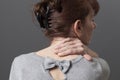 Middle aged lady with back or neck pain Royalty Free Stock Photo