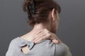 Middle aged lady with back or neck pain Royalty Free Stock Photo