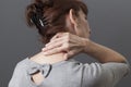 Middle aged lady with back or neck pain Royalty Free Stock Photo