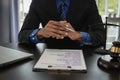 Middle-aged male lawyer working with legal contract documents in court room Justice with tee hammer and black scales on table, Royalty Free Stock Photo