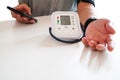 Middle-aged male patients with bp, heart rate, digital pulse monitoring device for elderly medical awareness in ischemic hypertens