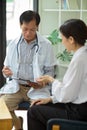 Middle-aged male specialist doctor examine diagnosis female patient