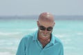 Middle-aged man on the beach in turquoise shirt Royalty Free Stock Photo