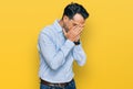 Middle aged man with beard wearing business shirt with sad expression covering face with hands while crying Royalty Free Stock Photo