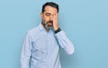 Middle aged man with beard wearing business shirt yawning tired covering half face, eye and mouth with hand Royalty Free Stock Photo