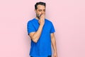 Middle aged man with beard wearing casual blue t shirt bored yawning tired covering mouth with hand Royalty Free Stock Photo