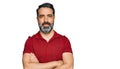 Middle aged man with beard wearing casual red t shirt happy face smiling with crossed arms looking at the camera Royalty Free Stock Photo