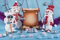 Merry adventures of snowmen under a green tree on new year's eve on a blue decorated stage Royalty Free Stock Photo