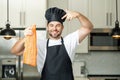 Middle aged man cooking fish salmon in kitchen. Chef on kitchen with fish salmon. Health, natural protein concept Royalty Free Stock Photo