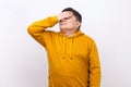 Middle aged man covers eyes, disgust from something shameful, scared afraid to see. Royalty Free Stock Photo