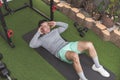 A middle-aged man does abdominal crunches while lying on the floor. Working out his core at his home gym Royalty Free Stock Photo