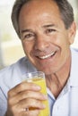 Middle Aged Man Drinking Fresh Orange Juice Royalty Free Stock Photo