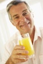 Middle Aged Man Drinking A Glass Of Orange Juice Royalty Free Stock Photo