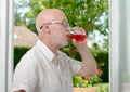 Middle-aged man drinking a glass of wine Royalty Free Stock Photo