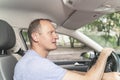 Middle aged man driving the car with attention on the road and fastened seat belt. Safe driving concept Royalty Free Stock Photo