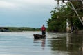 Afro-Colombian man navigating a canoe on the Magdalena River. Colombia.