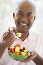 Middle Aged Man Eating Fresh Fruit Salad