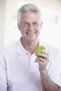 Middle Aged Man Eating Green Apple