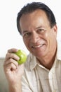 Middle Aged Man Eating Green Apple And Smiling Royalty Free Stock Photo