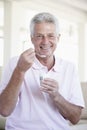 Middle Aged Man Eating Yogurt Royalty Free Stock Photo