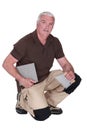 Middle-aged man fitting tiles Royalty Free Stock Photo