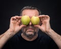 Middle-aged man with a green apples Royalty Free Stock Photo