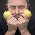 Middle-aged man with a green apples Royalty Free Stock Photo