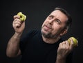 Middle-aged man with a green apples Royalty Free Stock Photo