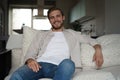 Middle-aged man having a restful moment relaxing in sofa.