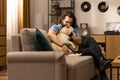 A middle-aged man hugs his dog after returning from work. A dog owner greets his pet after returning from class. The Royalty Free Stock Photo