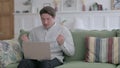 Young Man with Laptop Feeling Angry on Sofa