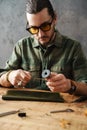Middle aged man leathersmith working at his workshop Royalty Free Stock Photo