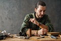 Middle aged man leathersmith working at his workshop Royalty Free Stock Photo