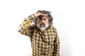 Middle aged man looking away with his hand on his head isolated on a white background