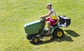 Middle-Aged Man Mowing lawn on riding mower Royalty Free Stock Photo