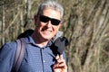 Middle-aged man hiking through the nature in a spring time with a big nice smile Royalty Free Stock Photo