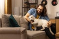 A middle-aged man plays with his dog after returning from work. The dog is man& x27;s best friend Royalty Free Stock Photo