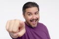 A middle aged man points forward with his finger while looking hyped, energized or maniacal. Choosing you. Headshot photo isolated