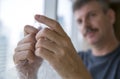 Middle aged man popping bubble wrap