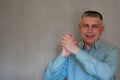 Middle aged man portrait. Greeting hands gesture of 40 years man looking at camera and smiling. Blue business shirt is dressed. Royalty Free Stock Photo